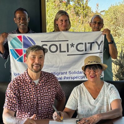 UWC Deputy Vice Chancellor-Academic, Professor Vivienne Lawack signing the MoU with Professor Harald Bauder (front); Prof Mulugeta Dinbabo, Dr. Leah Koskimaki, and Prof Razack Karriem (back) of UWC’s Institute for Social Development.